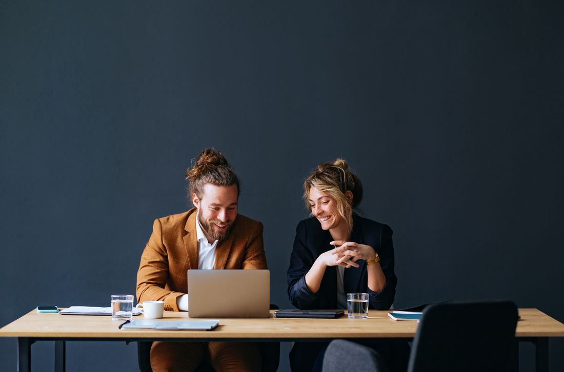 Colleagues working together on a laptop and tablet